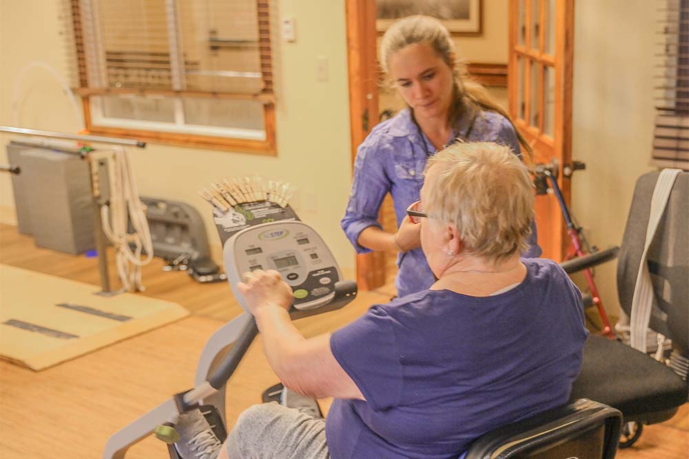 IMG_7352 - Rehab Bike 1 Person doing physical therapy with older woman